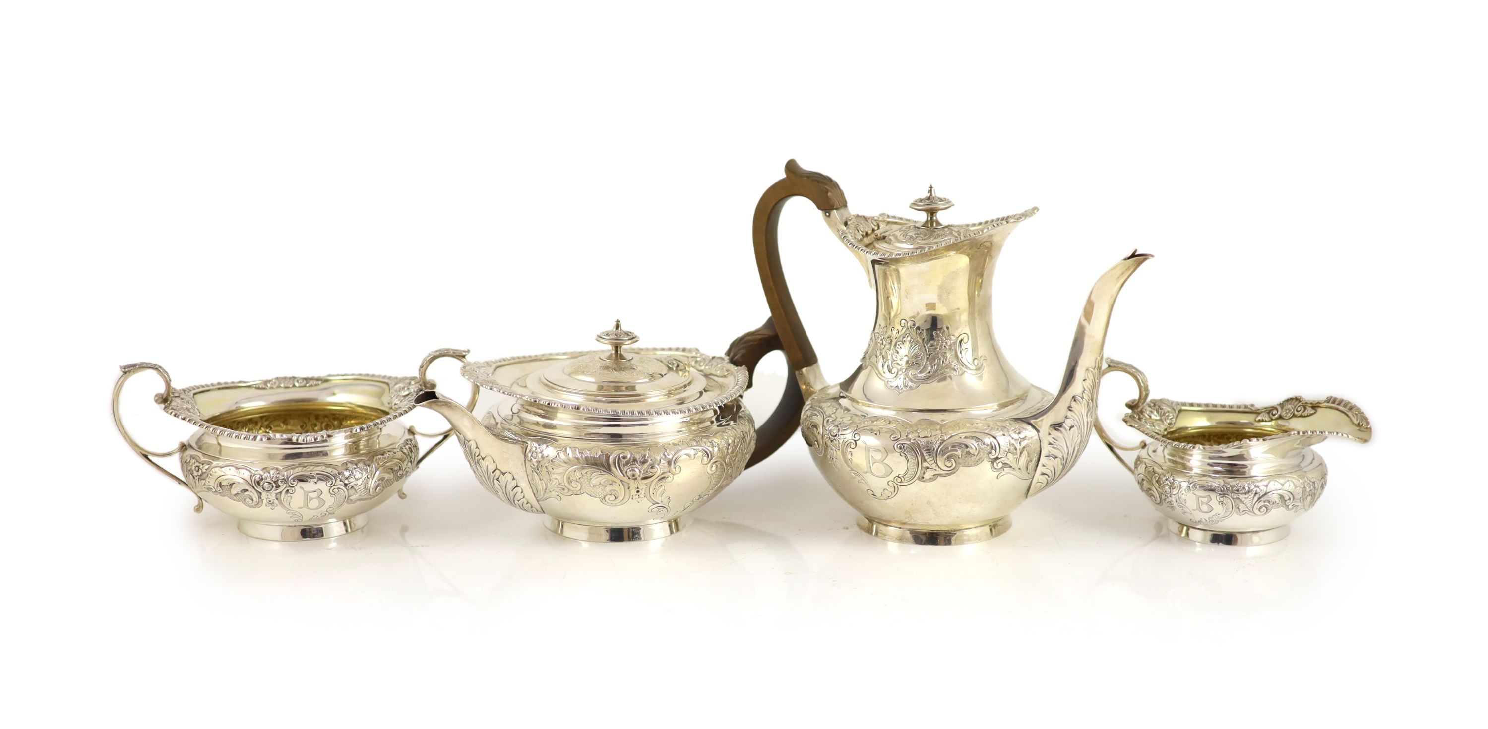 An Edwardian embossed silver circular four piece tea and coffee service by Edward Barnard & Sons Ltd